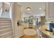 Bright kitchen near stairs and dining area features granite counters at 1105 Anemone Nw Way, Acworth, GA 30102