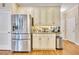 Kitchen with stainless refrigerator and granite counters near a pantry and doorways at 1105 Anemone Nw Way, Acworth, GA 30102