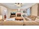 Comfortable living room with a fireplace, plush sectional sofa, and natural light from a window at 1105 Anemone Nw Way, Acworth, GA 30102