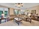 Open-concept living room with neutral carpet, large sectional, and view of a deck through large windows at 1105 Anemone Nw Way, Acworth, GA 30102