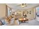 Open living room with large windows, plush sectional, view to kitchen, and access to front entryway at 1105 Anemone Nw Way, Acworth, GA 30102