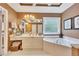 Bright bathroom featuring a corner soaking tub, vanity with storage, and large mirror at 1105 Anemone Nw Way, Acworth, GA 30102