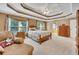 Spacious main bedroom features tray ceilings, a ceiling fan, and access to the ensuite bathroom at 1105 Anemone Nw Way, Acworth, GA 30102