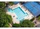 Top-down shot of a community pool with lounge chairs and nearby tennis courts at 1105 Anemone Nw Way, Acworth, GA 30102