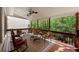 Covered porch with outdoor seating, wooded views, and a ceiling fan at 1105 Anemone Nw Way, Acworth, GA 30102