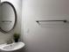 Clean bathroom featuring a modern sink, oval mirror, and neutral wall color at 1632 Lenox Overlook Ne Rd, Brookhaven, GA 30329