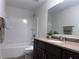 A full bathroom with granite countertop, dark vanity, and tub/shower combination at 1632 Lenox Overlook Ne Rd, Brookhaven, GA 30329