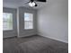This bedroom features neutral walls, plush carpeting, and two windows with blinds at 1632 Lenox Overlook Ne Rd, Brookhaven, GA 30329