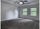 Open bedroom design with plush carpet, tray ceilings, and windows with natural light at 1632 Lenox Overlook Ne Rd, Brookhaven, GA 30329