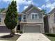 Charming two-story townhome with a neutral color scheme, two-car garage, and a well-maintained front yard at 1632 Lenox Overlook Ne Rd, Brookhaven, GA 30329