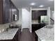 Well-equipped kitchen featuring granite countertops, stainless steel appliances, and dark wood cabinets at 1632 Lenox Overlook Ne Rd, Brookhaven, GA 30329