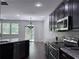 Modern kitchen with granite countertops, stainless steel appliances, and dark wood cabinets at 1632 Lenox Overlook Ne Rd, Brookhaven, GA 30329