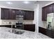 Gourmet kitchen featuring granite countertops, stainless steel appliances, and dark wood cabinetry at 1632 Lenox Overlook Ne Rd, Brookhaven, GA 30329