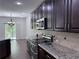 Elegant kitchen featuring stainless steel appliances, granite countertops, and dark wood cabinetry at 1632 Lenox Overlook Ne Rd, Brookhaven, GA 30329
