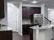 Open kitchen design with granite island, stainless steel appliances, and dark wood cabinets at 1632 Lenox Overlook Ne Rd, Brookhaven, GA 30329