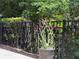A potted plant with pink flowers sits near a black metal fence at 1632 Lenox Overlook Ne Rd, Brookhaven, GA 30329