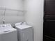 Laundry room with washer, dryer, wire shelf and dark cabinets at 1632 Lenox Overlook Ne Rd, Brookhaven, GA 30329