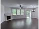 Spacious living room with hardwood floors, a fireplace, large windows, and sliding glass doors at 1632 Lenox Overlook Ne Rd, Brookhaven, GA 30329