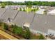 Aerial view of townhome backyards with fences and patio seating; ideal for outdoor relaxation at 2141 Slick Stone Dr, Snellville, GA 30078
