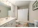 A well-lit bathroom with a vanity, toilet, and a shower with a curtain at 2141 Slick Stone Dr, Snellville, GA 30078