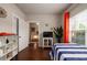 Bright bedroom with hardwood floors, a twin bed, and a view of the hallway and foyer at 2141 Slick Stone Dr, Snellville, GA 30078