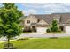 Well-maintained townhome with a two-car garage, beautiful landscaping, and a welcoming front yard at 2141 Slick Stone Dr, Snellville, GA 30078
