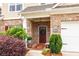 Inviting front entrance with a wreath-adorned door, brick accents, and well-maintained landscaping at 2141 Slick Stone Dr, Snellville, GA 30078