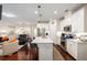 Open-concept kitchen with a large island, stainless steel appliances, and access to the living area at 2141 Slick Stone Dr, Snellville, GA 30078