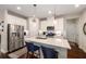 Bright eat-in kitchen featuring a center island, white cabinets, and stainless steel appliances at 2141 Slick Stone Dr, Snellville, GA 30078
