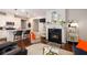 Cozy living room with fireplace, built-in shelves and seamless flow into kitchen at 2141 Slick Stone Dr, Snellville, GA 30078