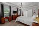 Spacious main bedroom with tray ceiling, dark curtains, and ample natural light at 2141 Slick Stone Dr, Snellville, GA 30078