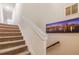 Carpeted staircase with white railing and a decorative cityscape artwork on the wall at 2141 Slick Stone Dr, Snellville, GA 30078