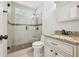 Updated bathroom featuring a glass shower with pebble floor and granite vanity top at 3463 Dunbar Ln, Suwanee, GA 30024