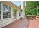 Wooden deck featuring a small table and access to the home's interior at 3463 Dunbar Ln, Suwanee, GA 30024