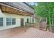 Multi-level deck with wooden railings and staircase in a wooded backyard at 3463 Dunbar Ln, Suwanee, GA 30024