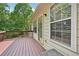 Wooden deck offering peaceful views of the surrounding greenery and wooded areas at 3463 Dunbar Ln, Suwanee, GA 30024