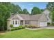 Inviting brick home with lush green lawn, mature trees, and attached two-car garage at 3463 Dunbar Ln, Suwanee, GA 30024