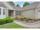 Close-up view of brick facade, tidy landscaping, and pathway to front door at 3463 Dunbar Ln, Suwanee, GA 30024