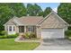 Charming brick home boasts a two-car garage and beautifully landscaped front yard at 3463 Dunbar Ln, Suwanee, GA 30024