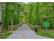 Tree-lined bridge walkway leading through the Ivy Creek Greenway with clear blue skies on a sunny day at 3463 Dunbar Ln, Suwanee, GA 30024