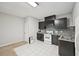 Cozy kitchen area featuring dark cabinets, subway tile backsplash, and white appliances at 3463 Dunbar Ln, Suwanee, GA 30024