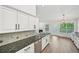 Well-equipped kitchen with granite countertops, white cabinets, and stainless steel appliances at 3463 Dunbar Ln, Suwanee, GA 30024