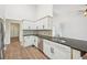 Open kitchen featuring stainless steel appliances, white cabinetry, and granite countertops at 3463 Dunbar Ln, Suwanee, GA 30024