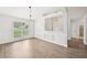 Bright living room featuring modern wainscoting, neutral walls, and a large window at 3463 Dunbar Ln, Suwanee, GA 30024
