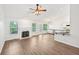 Spacious living room with fireplace, hardwood floors, and access to outdoor patio at 3463 Dunbar Ln, Suwanee, GA 30024