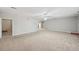 Large living room space featuring neutral walls, plush carpeting and ample natural light at 3463 Dunbar Ln, Suwanee, GA 30024