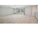Spacious living room featuring neutral carpet, fan and access to an outdoor deck at 3463 Dunbar Ln, Suwanee, GA 30024
