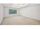 Spacious main bedroom with large window and tray ceiling with ceiling fan at 3463 Dunbar Ln, Suwanee, GA 30024