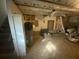 View of the unfinished basement showing the stairs, water heater, and exposed ceiling at 4865 Surrey Dr, Roswell, GA 30075