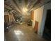 Unfinished basement with exposed ceiling and shelving unit offers potential for customization at 4865 Surrey Dr, Roswell, GA 30075